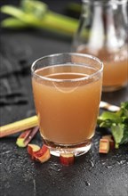 Portion of fresh made Rhubarb Juice (close up shot, selective focus)