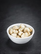 Portion of Garlic (preserved) on a rustic slate slab (selective focus, close-up shot)