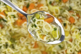 Portion of homemade Alphabet Soup (selective focus, close-up shot)