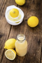 Lemon Juice on a vintage background as detailed close-up shot (selective focus)