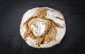 Fresh made Wholemeal Bun on a vintage background (close-up shot)