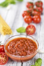 Pasta Sauce (Tomato taste) as high detailed close-up shot on a vintage wooden table (selective