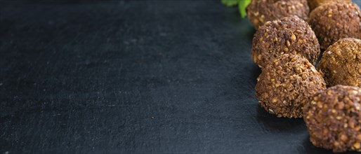 Wooden table with Falafels (close-up shot, selective focus)