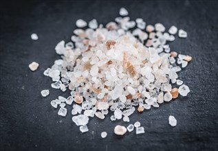 Portion of Himalayan Salt on a rustic slate slab (selective focus, close-up shot)