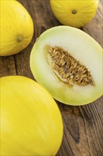 Honeydew Melon on rustic wooden background (close-up shot)