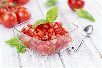 Diced Tomatoes on a vintage background as detailed close-up shot (selective focus)