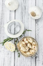 Fresh made Garlic (preserved) on a vintage background (close-up shot)