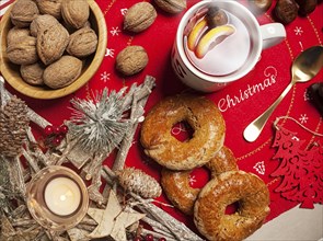 Cup of hot tea with lemon and cinnamon on the Christmas table, view from above