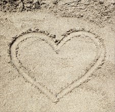 Heart drawn in the sand of Baia Verde Beach near Gallipoli, Salento, Italy, Europe