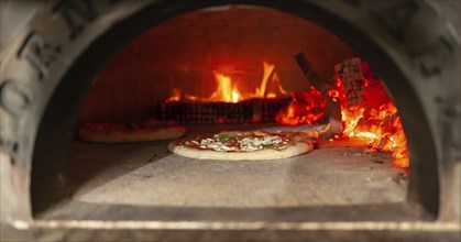 Cooking a margherita pizza in a wood oven