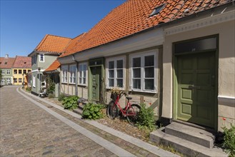 Old town of Rudkobing, renovated houses, colourful row of houses, decorative design, bicycle,