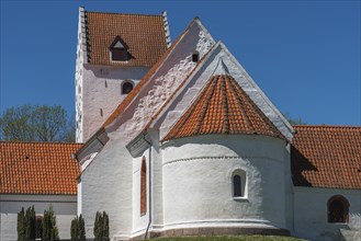 Lindelse Kirke, typical Danish church from 1830, whitewashed, red tiled roof, hill, steeple with