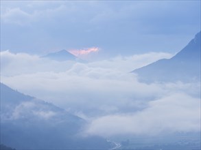 Evening clouds and fog over the Liesingtal, in the valley the village of Traboch, Schoberpass