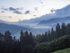 Evening clouds and fog over the Liesingtal, in the valley the village of Traboch, Schoberpass