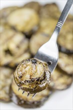 Homemade Antipasti (Grilled Zucchinis) on vintage background (selective focus, close-up shot)