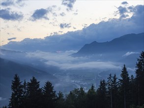 Evening clouds and fog over the Liesingtal, in the valley the village of Traboch, Schoberpass