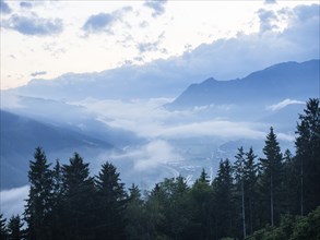 Evening clouds and fog over the Liesingtal, in the valley the village of Traboch, Schoberpass