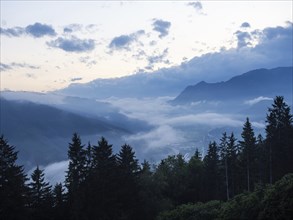 Evening clouds and fog over the Liesingtal, in the valley the village of Traboch, Schoberpass