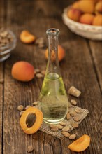 Portion of Apricot Oil with some fresh fruits as detailed close up shot (selective focus)