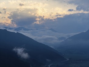 Evening clouds and fog over the Liesingtal, in the valley the village of Traboch, Schoberpass