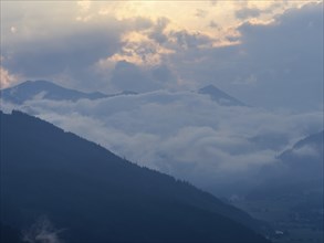 Evening clouds and fog over the Liesingtal, in the valley the village of Traboch, Schoberpass