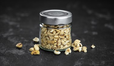 Freshly chopped Hazelnuts as detailed close up shot (selective focus)