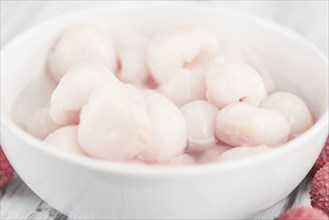 Fresh made Lychees (preserved) on a vintage background (close-up shot)