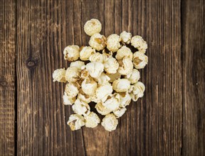 Fresh made Popcorn on an old and rustic wooden table, selective focus, close-up shot