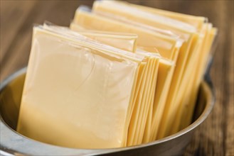 Sliced Cheese on a vintage background as detailed close-up shot (selective focus)