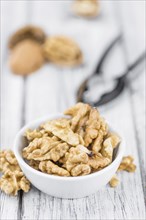 Walnut kernels on a vintage background as detailed close-up shot (selective focus)