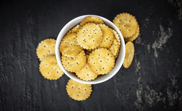 Portion of mixed Snacks on dark background (detailed close up shot, selective focus)