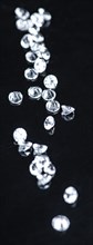 Small Diamonds on dark background as close up shot (selective focus)