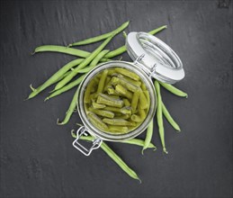 Preserved Green Beans as detailed close-up shot (selective focus) on vintage background