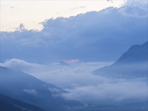 Evening clouds and fog over the Liesingtal, in the valley the village of Traboch, Schoberpass