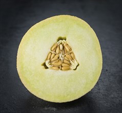 Honeydew Melon on a vintage background as detailed close-up shot (selective focus)