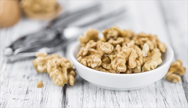 Walnut kernels on a vintage background as detailed close-up shot (selective focus)