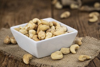 Portion of roasted Cashew Nuts (close up shot, selective focus)