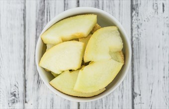 Honeydew Melon on a vintage background as detailed close-up shot (selective focus)