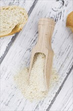 Old wooden table with fresh Breadcrumbs (close-up shot, selective focus)