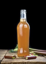 Rhubarb Juice on a rustic background (close up shot, selective focus)