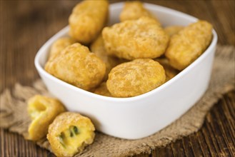 Homemade Cheese Nuggets (with Chilis) on vintage background (selective focus, close-up shot)