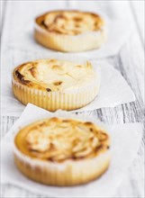 Homemade Cheesecake on an wooden table (selective focus) as detailed close-up shot