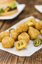 Homemade Cheese Nuggets (with Chilis) on vintage background (selective focus, close-up shot)