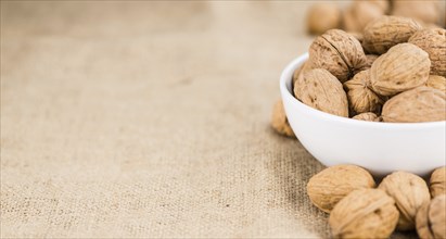 Walnuts on a vintage background as detailed close-up shot (selective focus)