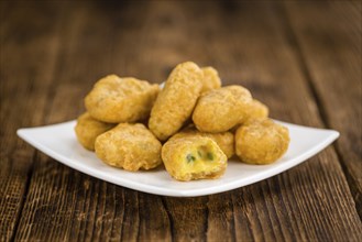 Chili Cheese Nuggets on a vintage background as detailed close-up shot (selective focus)