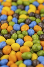 Chocolate coated peanuts as detailed close up shot (selective focus)