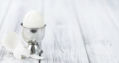 Some boiled Eggs (close-up shot, selective focus) on an old wooden table