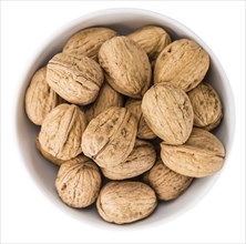 Portion of Walnuts (as close-up shot) isolated on white background