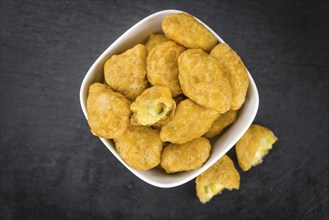 Homemade Cheese Nuggets (with Chilis) on vintage background (selective focus, close-up shot)