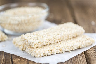 Fresh made Quinoa Bars (selective focus, close-up shot) on an old wooden table